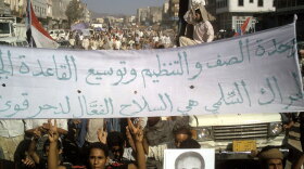 Yemeni protesters hold pro-al-Qaida banners and wave the victory sign during a demonstration in the Radfan district of Lahj in southern Yemen on Dec. 24.