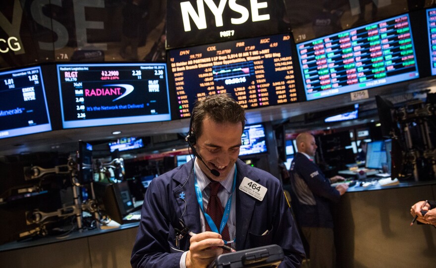 For the first time in its history, the Dow Jones industrial average closed above 16,000 points Thursday. The index of 30 stocks touched the mark earlier this week, when a trader was photographed at the New York Stock Exchange.