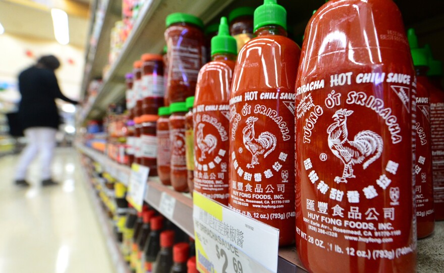 Bottles of Sriracha chili sauce on the shelves of a supermarket in Rosemead, Calif.