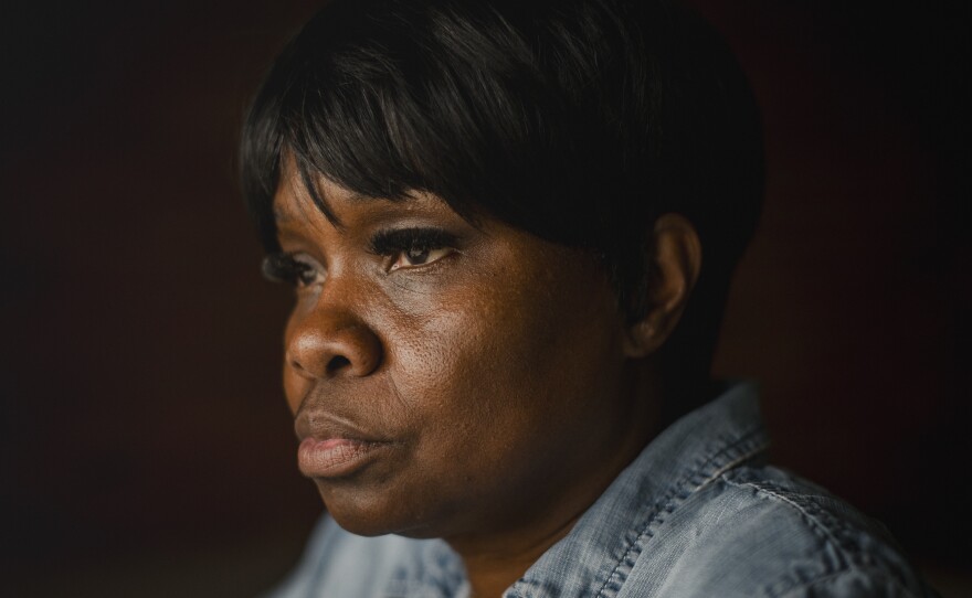 Tanya Warden, 55, sits for a portrait at her workplace in Philadelphia, Pennsylvania, on March 26, 2024. Warden's son, Tyron Alexander, was shot multiple times and died in October 2020.