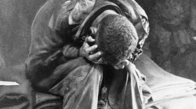 An American soldier collapses in his hands from the strain of fighting along the Taegu front, South Korea, 1950.