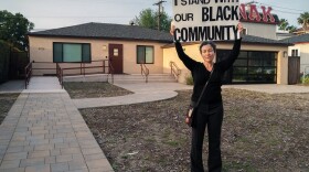 Dania Brett, a staff member at San Diego State University, stands in front of the SDSU Black Resource Center with a sign that says 'I stand with our Black community' on Monday, April 15, 2019, after hearing about the vandalism that happened Friday, April 12, 2019.