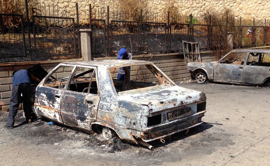 Boys search destroyed cars for salvageable parts in Silvan, a town facing repeated clashes between Turkish forces and militant Kurdish youth.