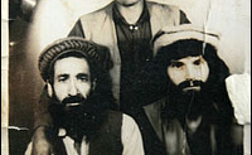 Tseuma spent years as a prisoner of mujahedeen fighters. In this photo, taken after his release, he is pictured on the right, along with two of his Afghan friends. While with the mujahedeen, Tseuma converted to Islam, adopted the Afghan name Nik Mohammed, and dyed his beard and hair black to better fit in with Afghan society. Today, he has allowed his hair to go back to its natural red color.