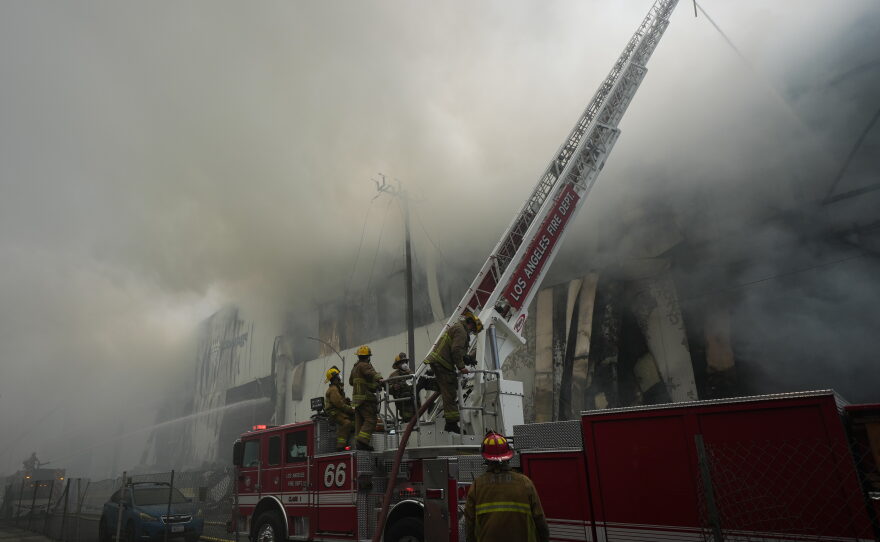 Firefighters fight a warehouse fire in the Boyle Heights neighborhood of Los Angeles, Sunday, June 21, 2026.