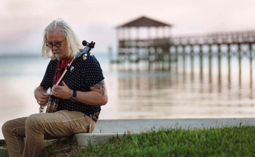 In the three-part program BILLY CONNOLLY’S TRACKS ACROSS AMERICA, Scottish comedian Billy Connolly (pictured playing a bango by the water) travels from Chicago to New York on a 6,000 mile, 26-state train journey through the “backyard of America."