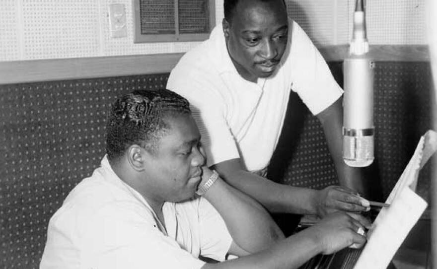 Fats Domino (seated) and Dave Bartholomew, producer/songwriter/bandleader and longtime collaborator, who co-wrote and produced most of Fats’ hits, at piano.