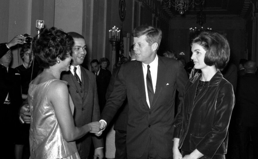 President and Mrs. Kennedy greet Clarence C. Feurgeson Jr., counsel to the Civil Rights Commission, and his wife, at the White House reception.