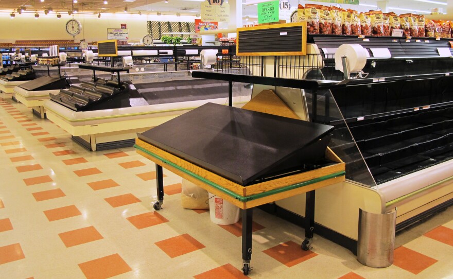 The aisles and food cases are largely empty inside a Market Basket in Somerville, Mass. Workers have disrupted operations.