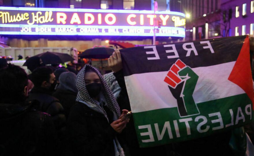 Pro-Palestinian demonstrators gather for the "Flood Manhattan for Gaza" rally outside Radio City Music Hall while President Biden holds a fundraiser for his reelection campaign in New York on Thursday.