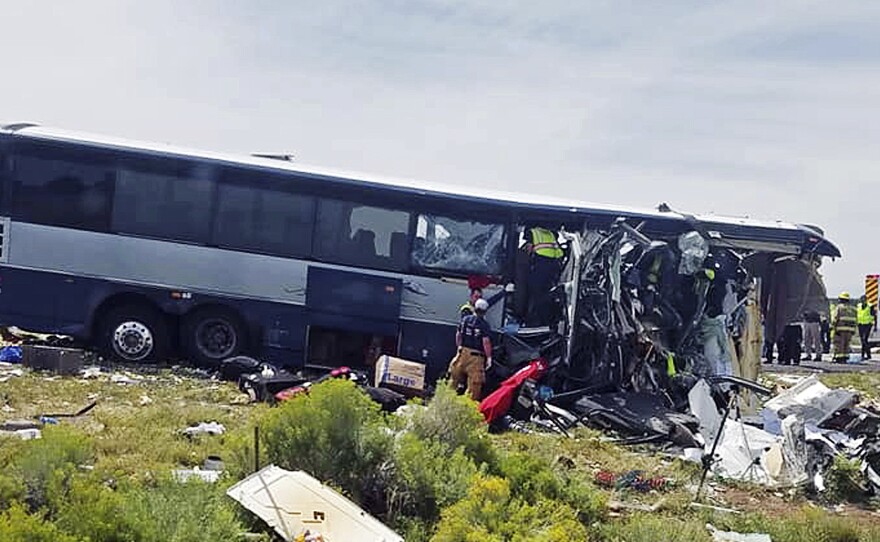 First responders work the scene of a collision between a Greyhound passenger bus and a semi-truck Thursday on Interstate 40 near the town of Thoreau, N.M., near the Arizona border. Multiple people were killed and others were seriously injured.