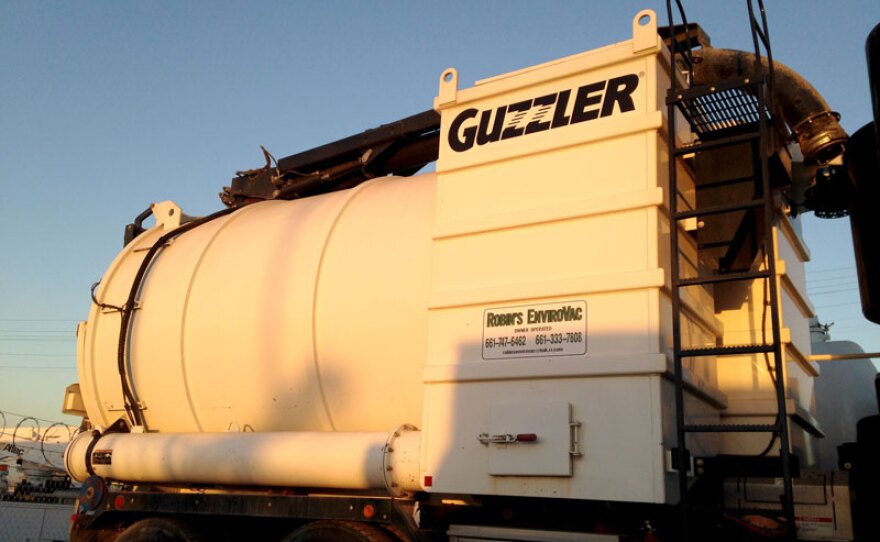 A picture of a hydro-excavation truck, called The Guzzler, at Robin's Envirovac work yard in Bakersfield.