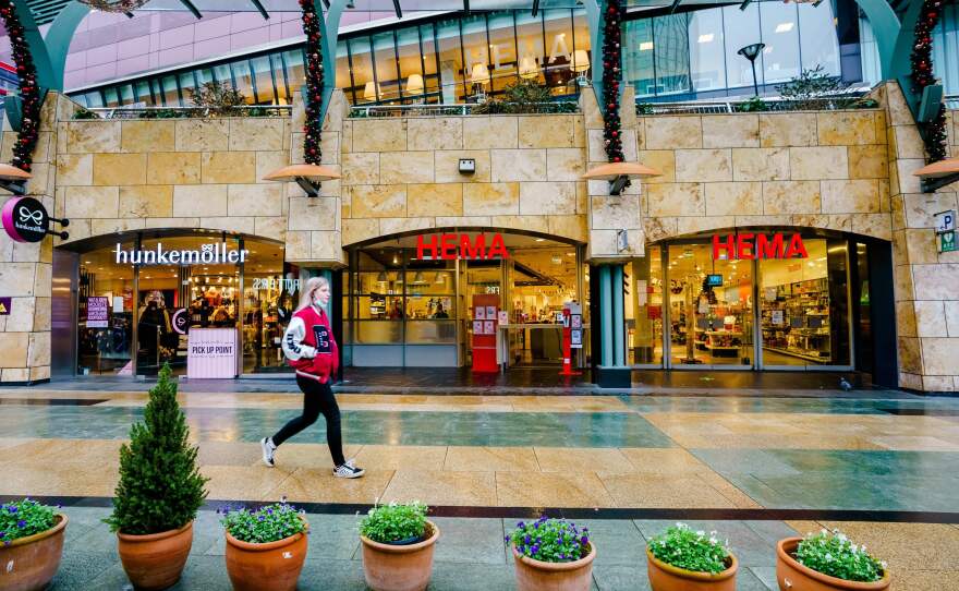 A passer-by walks downtown Rotterdam on December 19, 2021, as the Netherlands have gone into "lockdown" over the Christmas period to try to stop a surge of the Omicron coronavirus variant, Dutch Prime Minister Mark Rutte said on Dec. 18, 2021.