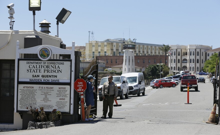 A Department of Corrections officer guards the main entryway leading into San Quentin State Prison in San Quentin, Calif., July 24, 2019.