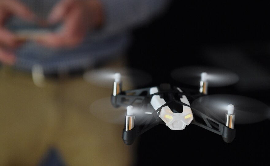 Technology journalist Tim Stenovec controls a Parrot Minidrone "Rolling Spider" during a demonstration in June in New York.