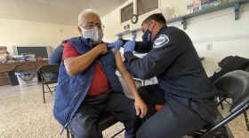 Juan Carlos Padilla gets his COVID-19 vaccination inside the community center of Terry's Mobile Home Park in Chula Vista, Feb. 17, 2021.	