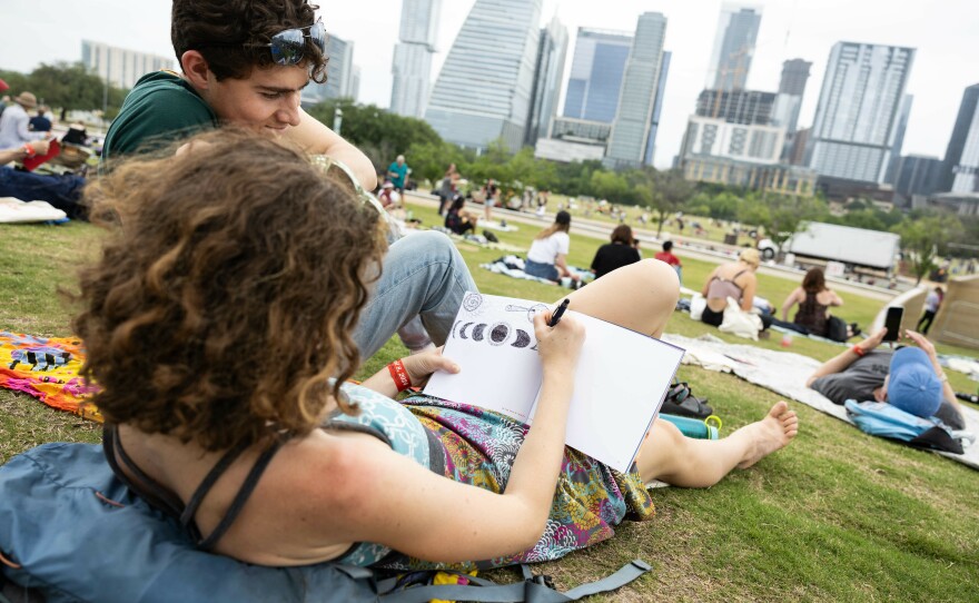 A woman drawing the eclipse during the watch party at The Long Center for the Performing Arts in Austin, Texas.