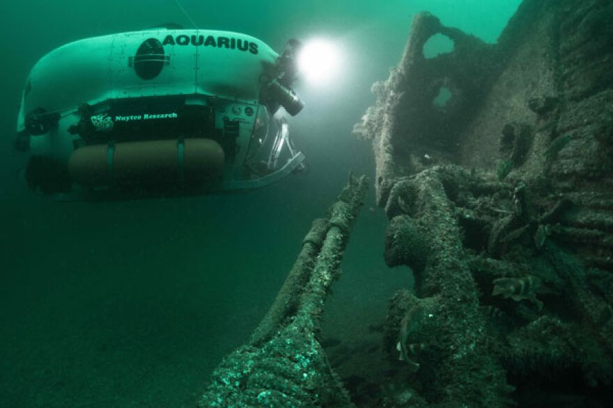 The submarine Aquarius approaches the shipwreck HMS Lawford.