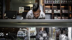 Jerred Kiloh, owner of the Higher Path medical marijuana dispensary, stocks shelves with with cannabis products in Los Angeles, June 27, 2017. 