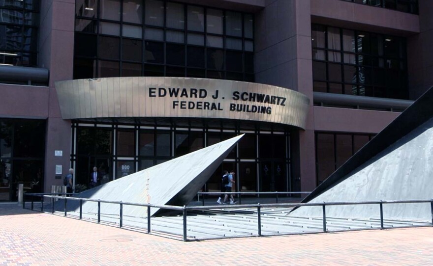 People walking in front of the Edward J. Schwartz Federal Building, where immigration court hearings are held, Aug. 6, 2025.