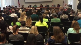 Attendees listen during a Poway Unified School District Board of Education meeting, May 31, 2016.