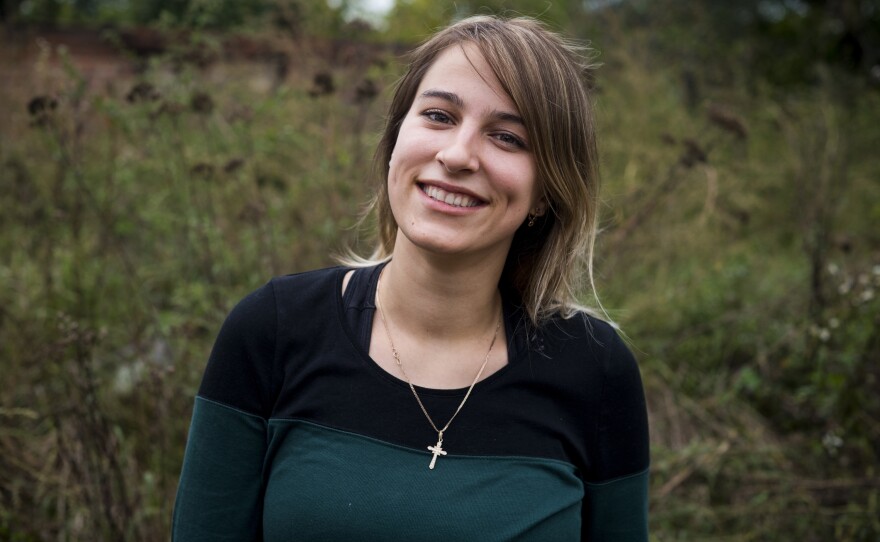 Liza Kochubei, 26, works to clean up a home belonging to the family of Tetiana Vereshchahina in Kolychivka on Oct. 1.