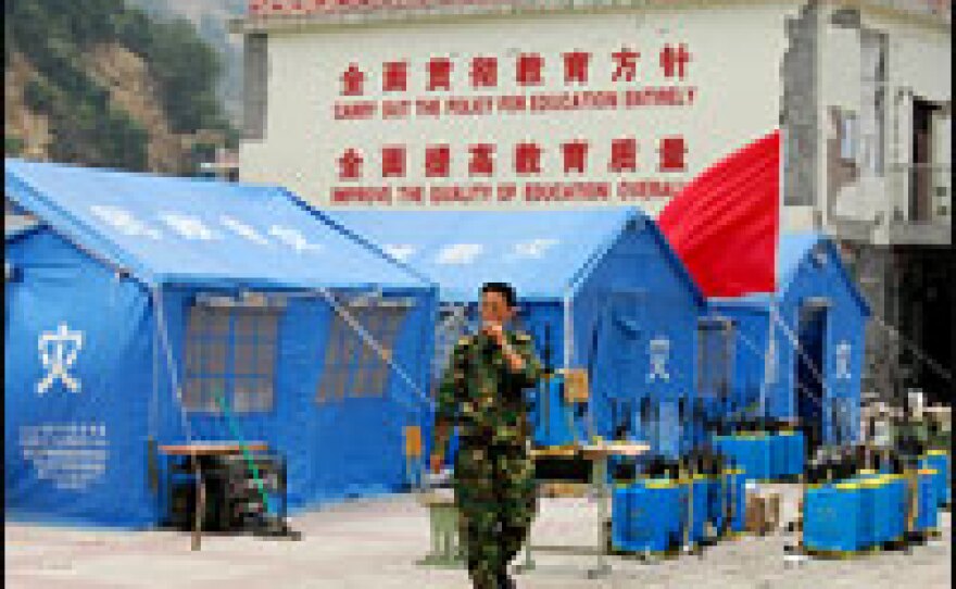 The standing wall of the middle school in Yingxiu reads: "Carry out the policy for education entirely, improve the quality of education overall."
