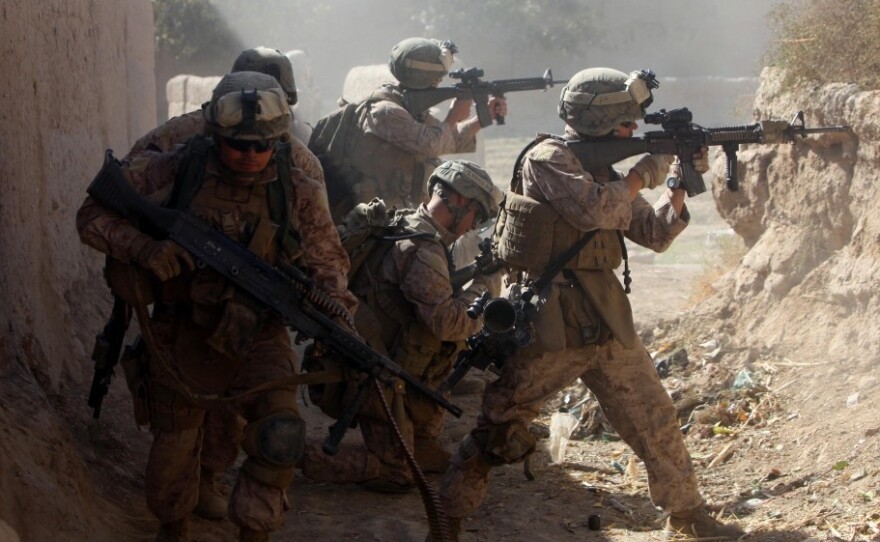 <p>U.S. Marines with 3rd Battalion, 5th Regiment and the Afghan National Army provide cover as they move out of a dangerous area after taking enemy sniper fire during a security patrol in Sangin, Afghanistan, in November 2010. During its seven-month deployment, the 3/5 sustained the highest casualty rate of any Marine unit during the Afghan war, losing 25 men.</p>