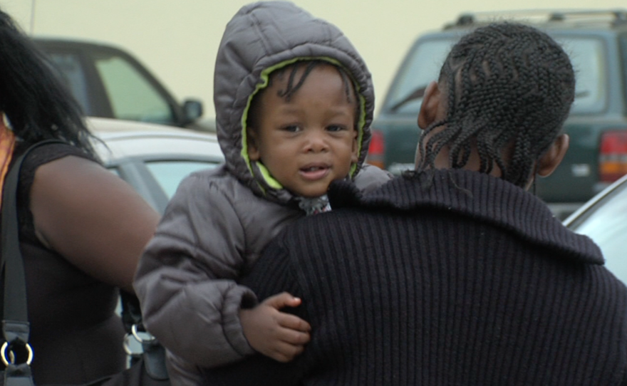 A Haitian woman carries a child in Tijuana, Sept. 20, 2016.