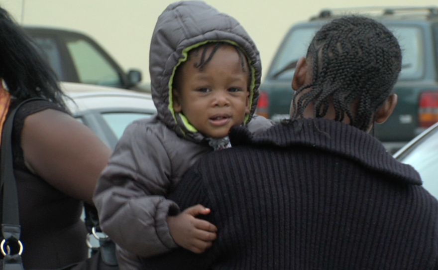 A Haitian woman carries a child in Tijuana, Sept. 20, 2016. 