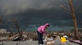 Janet Martin attempts to salvage medication and mementos from her brother's home before a second storm moves in, on May 23, 2011 in Joplin, Missouri. 