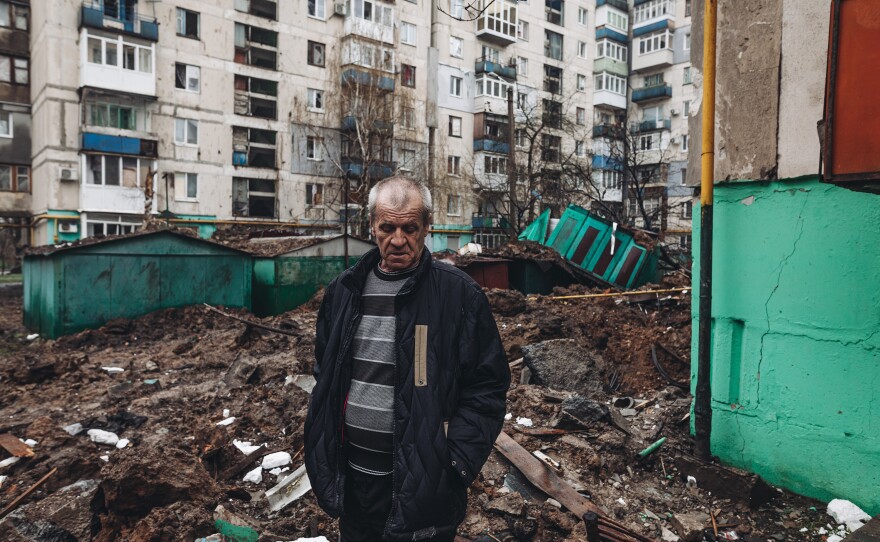 An Ukrainian man stands among the ruins at a residential area damaged by shelling in Lysychansk, Ukraine, on Wednesday.