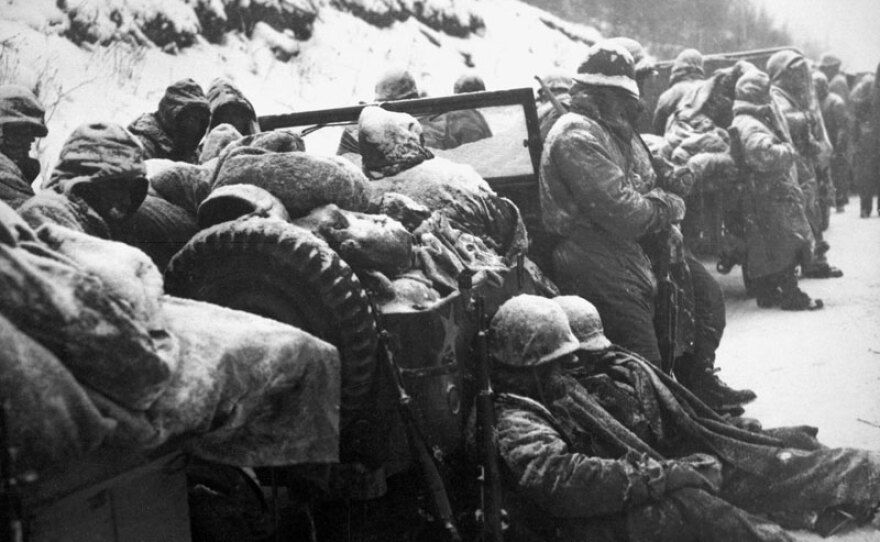 U.S. Marines rest on the road during their withdrawal from the Chosin Reservoir, North Korea. Nov. 29 - Dec. 3, 1950.