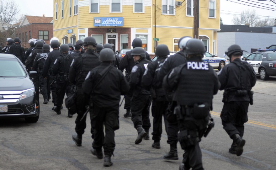 Police walk down School and Walnut Street on April 19, 2013 in Watertown, Massachusetts. Earlier, a Massachusetts Institute of Technology campus police officer was shot and killed at the school's campus in Cambridge.
