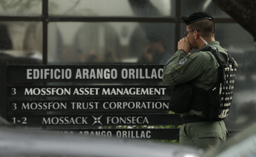 A police officer stands outside the Mossack Fonseca law firm Tuesday as organized crime prosecutors raid the offices in Panama City.