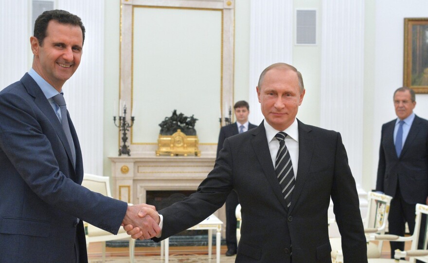 Russian President Vladimir Putin (right) hosts Syrian President Bashar Assad during a meeting at the Kremlin in Moscow. The meeting took place in October, shortly after Russia began a bombing campaign in Syria in support of Assad. Putin abruptly announced Monday that Russia was withdrawing most of its military forces.