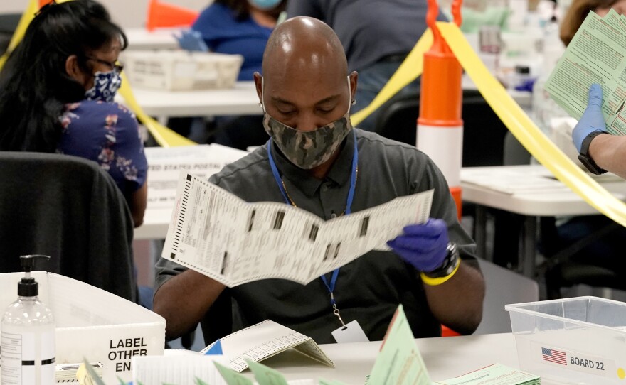 Election workers sort ballots at the Maricopa County Recorder's Office in Phoenix.