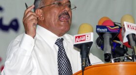 Yemeni President Ali Abdullah Saleh gives a speech at Sanaa University on Tuesday as vast numbers of protesters poured into a nearby square for a massive anti-regime rally.