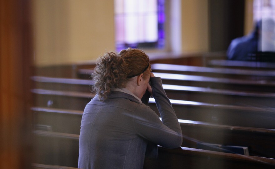 A woman prays at Saint Rose of Lima Roman Catholic Church in Newtown, Conn., on Saturday.
