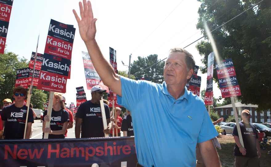 Republican presidential candidate John Kasich greets supporters at the Labor Day parade in Milford, N.H. earlier this month.