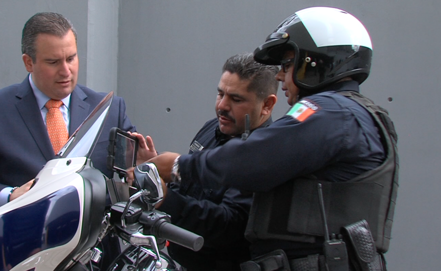 Tijuana's police chief Alejandro Lares discusses smart tablets with his officers, Jan. 15, 2016.