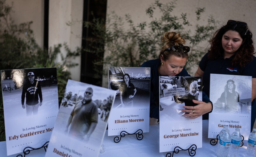 Savannah Sampson, right, and Nicole Lewis, help set up a vigil for the victims of Tuesday's fatal SUV-Metro bus collision and the subsequent crash of a TV news helicopter that was covering it in the Chatsworth neighborhood of Los Angeles, Thursday, Sept. 17, 2026.