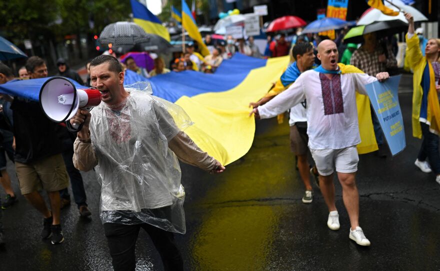 Members of the Australian-Ukrainian community carry a Ukrainian flag during a protest against Russia's invasion of Ukraine, in Sydney on Saturday.
