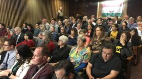 Members of the Rapid Response Network and of the public watch a San Diego County Board of Supervisors meeting on housing asylum seekers, Jan. 29, 2019.