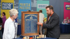 James Supp (right) appraises a Humphreys' homeopathic medicine cabinet in Omaha, Neb.