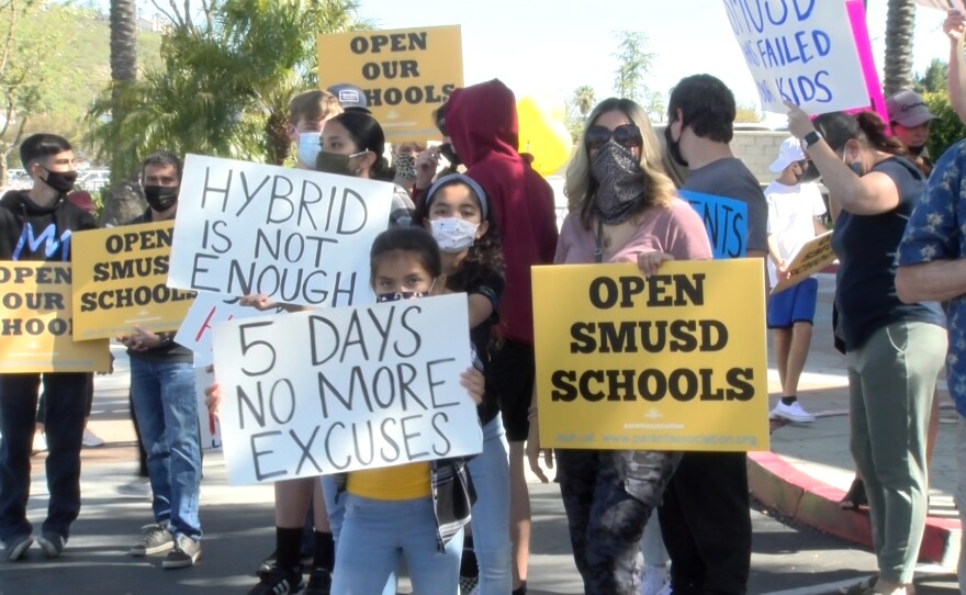 Parents and students rally outside the San Marcos Unified School district offices. April 19, 2021.