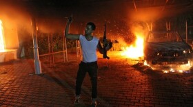 A vehicle and the surrounding area are engulfed in flames after it was set on fire inside the US consulate compound in Benghazi late on September 11, 2012. 