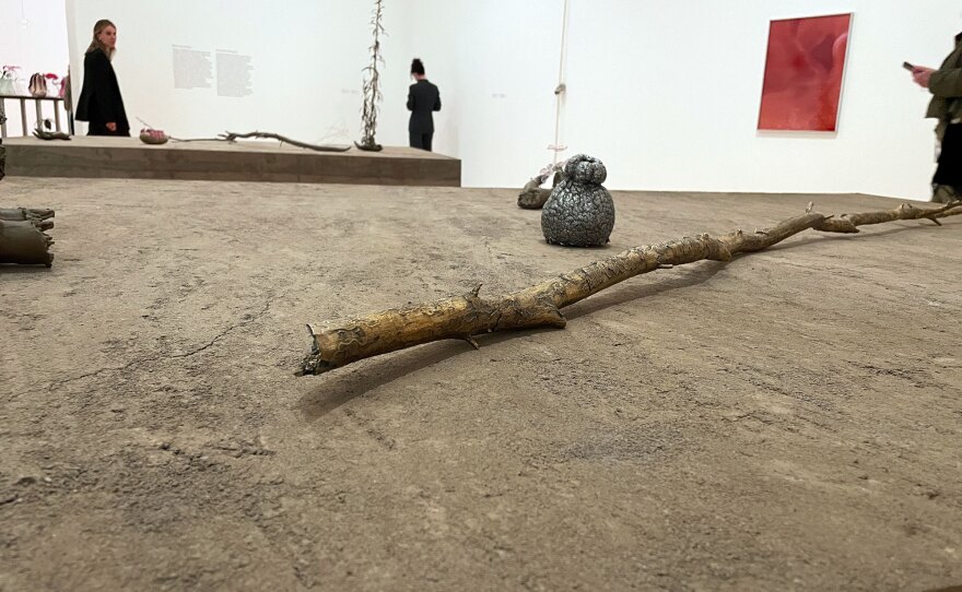 Kelly Akashi's bronze-cast branches modeled after trees at the Poston Japanese American World War II concentration camp are shown with other sculptures on a rammed earth pedestal, at MCASD La Jolla on Sept. 20, 2023.