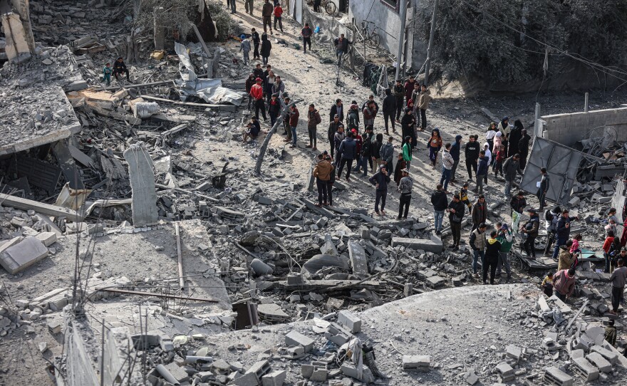 Palestinians inspect their destroyed homes after an Israeli air strike killed more than 60 people in Rafah, southern Gaza Strip, Feb. 12.