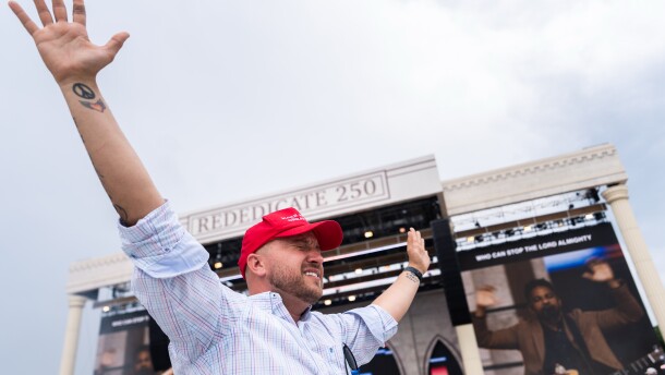 A person worships to Christian music at Rededicate 250, a mostly conservative Christian prayer gathering in honor of the United States' 250th anniversary, on the National Mall on Sunday.